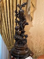 Full front view of the bronze sculpture showing overall form and proportions