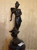 Full height view of patinated bronze figure on marble base
