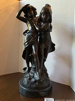 Full front view of the bronze sculpture with marble base