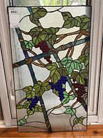 Full front view of stained glass panel hung in window