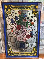 Full view of stained glass panel showing floral bouquet and decorative border