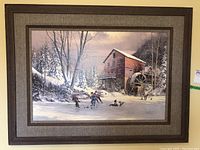 Frontal image showing the larger framed winter landscape print featuring kids skating on a frozen creek near a red mill building in snowy winter scenery.