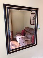 Full view of the framed wall mirror showing size and reflection.