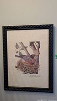 Framed bird illustration with dark twisted border and signature