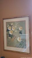 Framed Asian style print showing bird perched on a branch with flowers, close-up from the front.
