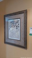 Side view of the framed print showing frame profile and hanging on wall.