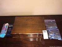 Wooden box containing the silver plate cutlery with polishing materials adjacent.