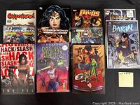 Photo showing 10 comic and graphic novels in TPB and HC format spread out on black background.