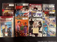 Photo showing 12 high-grade comic book sets with various colorful covers including superheroes and story arcs