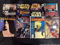 Photo displaying 12 comic books including Star Wars series, Batman, Love and Rockets, and other titles laid out on a flat surface, showing front covers and verifying condition