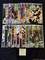 20 Justice League of America comics arranged in two rows, all bagged and boarded, featuring characters such as Batman, Superman, Wonder Woman, Flash, and Martian Manhunter.
