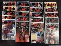 Photo showing 20 DC comics including Batman, Superman, Supergirl, Wonder Woman, and Titans. Comics are bagged and boarded and appear in like-new condition.