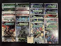 Twenty Green Lantern comic books neatly arranged in bag and board protection, showing the front covers with detailed art and titles.