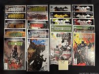 Photo showing 20 bagged and boarded Batman-related comics in two rows