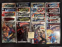 Photo of 20 Superman comic books arranged in 4 rows and 5 columns, all bagged and boarded.