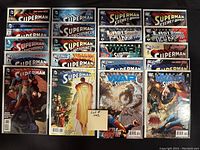 Photo showing all 20 Superman-themed comic books laid out and bagged/boarded.