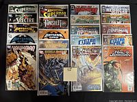 Photo of 20 comics featuring DC and Marvel characters, bagged and boarded.