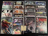 Photo showing 20 comics arranged in 4 columns including Justice League of America, Countdown, Nightwing, Punisher, War Journal, and Marvel Knights series, all bagged and boarded.
