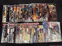 Photo showing 50 assorted comic books from various popular superhero and adventure titles, bagged and boarded.