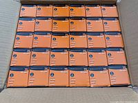 Top-down photo of 30 boxed GE PureSpectrum 75 watt light bulbs in a case.