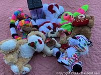 Lot of various new stuffed animals with tags showing different colors and designs