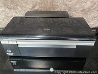 Front view of the Epson Stylus Photo printer showing the closed top and front panel with Epson branding.