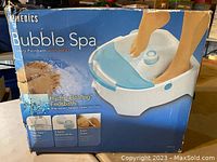 Box and packaging showing HoMedics Bubble Spa footbath with heat and features such as hydro healing footbath, effervescent bubbles, 2 salon attachments, super quiet operation.