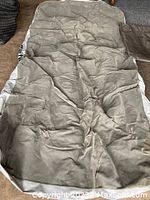 Full-size air mattress light gray color, synthetic fabric with wrinkles and some wear