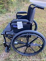 Side view showing frame, large rear wheel with six spokes, black padded armrest, and Invacare branding.