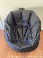 Front view of one black Big Joe bean bag chair showing overall shape and fabric condition.