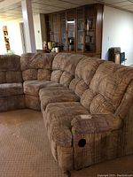 Side view showcasing the sectional sofa's patterned fabric upholstery and recliner handle on the armrest.