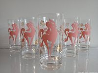 Photo showing all six pink pony highball cocktail glasses arranged in a triangular group, highlighting the overall set and design.