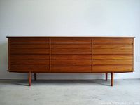 Full front view showing overall dresser with nine drawers and support legs