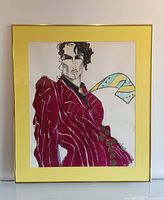 Frontal view of the framed avant-garde fashion portrait painting with yellow mat and glass reflection visible.