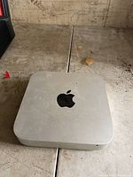 Top view of the Apple Mac mini showing the Apple logo on silver aluminum body.