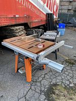 Perspective view of Ridgid table saw on folding stand outdoors