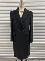 Full front view of men's long grey wool overcoat displayed on mannequin