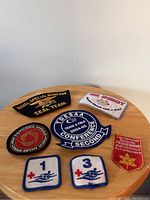 Top view photo showing the full set of seven patches on wooden table