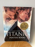 Front cover of Titanic Movie Poster Book showing James Cameron's Titanic with 12 pull-out posters label.