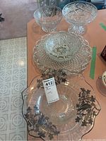 Overview of the crystal glassware collection including bowls and trays showing cut glass patterns and silver coating on one tray