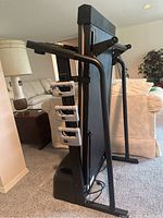 Folded Weslo Cadence treadmill showing side profile and hand grips