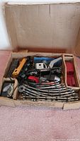 Box containing all train set components including engine, cars, tracks, switch track, and transformer.
