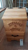 Front view of the wooden bin showing the "POTATOES & ONIONS" raised lettering and drawer below.