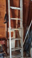 Full view of the 16ft aluminum extension ladder showing paint stains and wear.