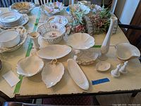 Full table view showing all items including candy dishes, vase, candle holder, butter dish, salt and pepper shakers, bowls, and dipping plates arranged for display.