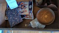 Mixed lot of ceramic plates, wood items including easels, and a glass item.