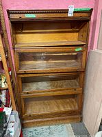 Front view of oak four-tier barrister bookcase with lift-up glass doors closed