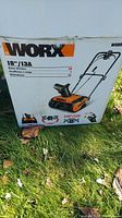 Original box of Worx WG650 snow thrower with model and specifications visible on front.