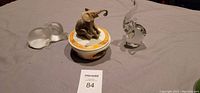 Three elephant figurines including Lenox music box and two glass elephants