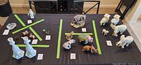 Table shot showing multiple animal figurines including the Lenox elephants in one corner.